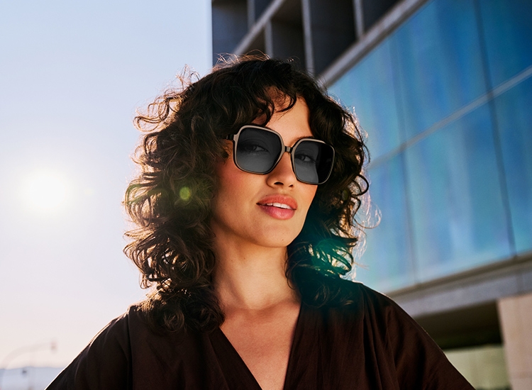Mulher usa óculos de sol com lentes ColorMatic